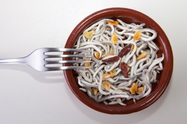 Bowl with imitation young eels cooked clipart