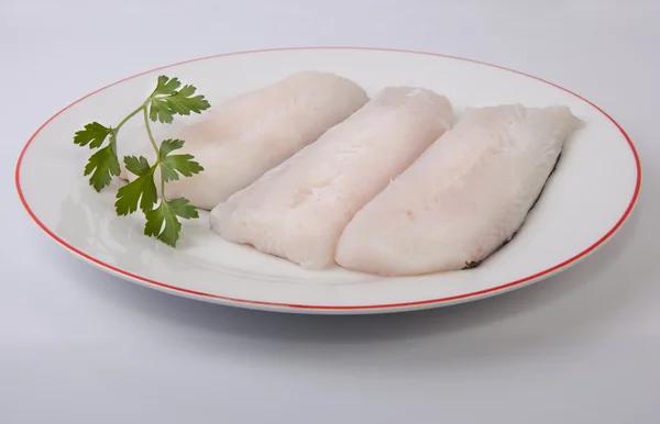 Hake steaks on plate — Stock Photo, Image