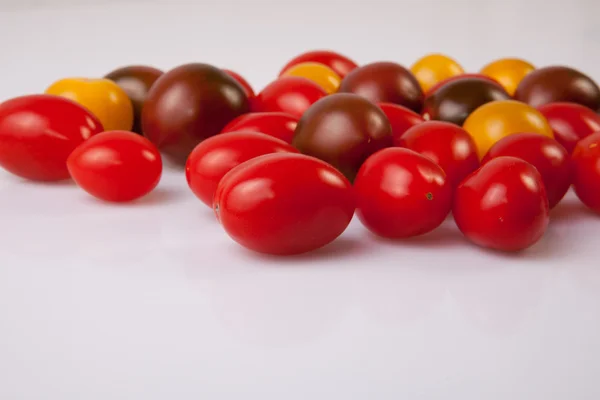 Handful of colorful cherry tomatoes — Stock Photo, Image