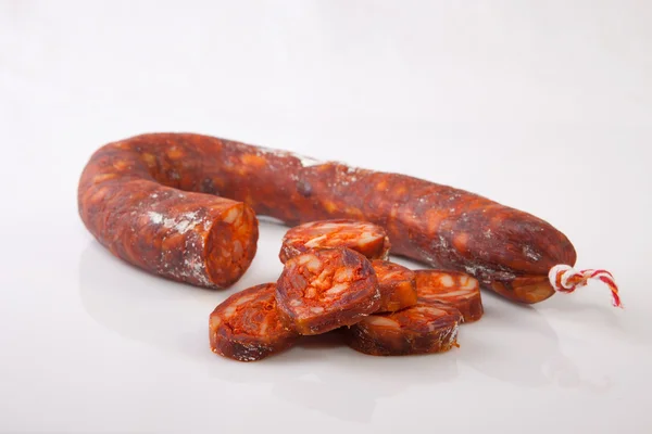 Red iberian chorizo with some cut pieces — Stock Photo, Image
