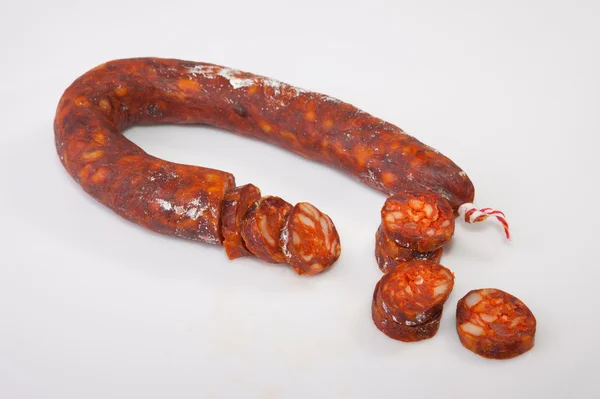 Red iberian chorizo with some cut pieces — Stock Photo, Image