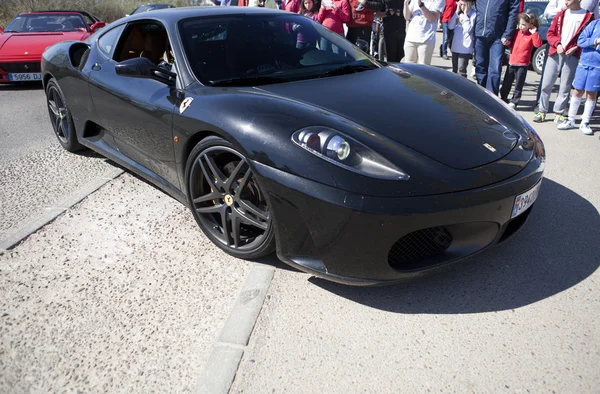 Black Ferrari car entering at resort facilities — Stock Photo, Image