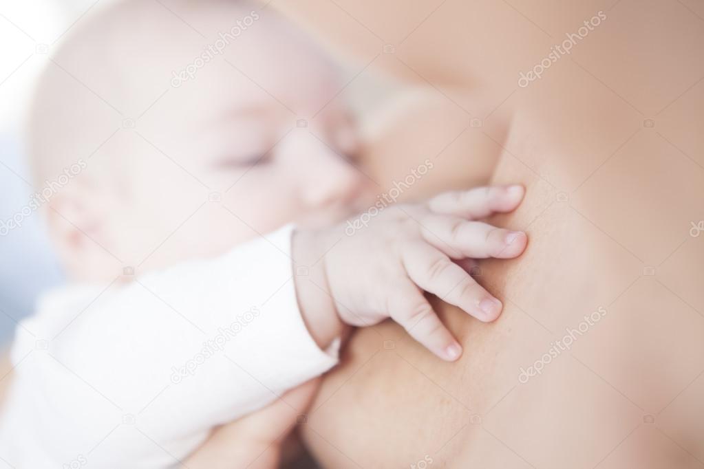 Baby hand closeup while he is breastfed