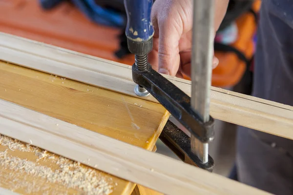 Carpenter fastening a clamp — Stock Photo, Image