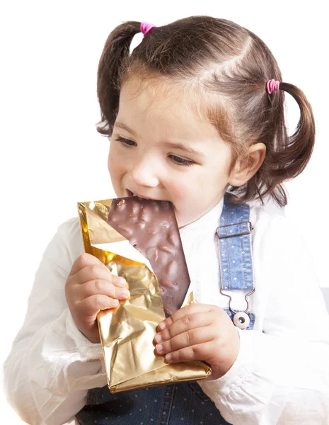 Portrait of happy girl eating chocolate — Stock Photo, Image