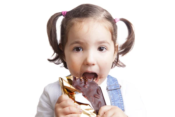 Portrait of happy girl eating chocolate — Stock Photo, Image