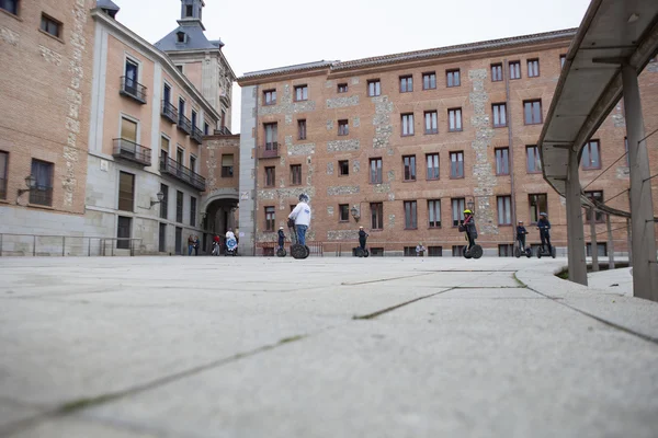 Tourists sightseeing on segway tour of Madrid, old town — Stock Photo, Image