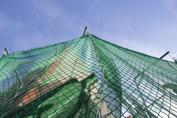 Hanging protection net on building construction site — Stock Photo, Image