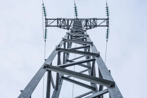 High voltage power pylons against blue sky — Stock Photo, Image