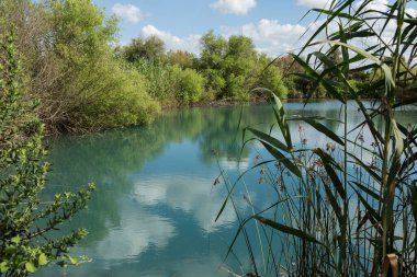 White clouds float on the blue river