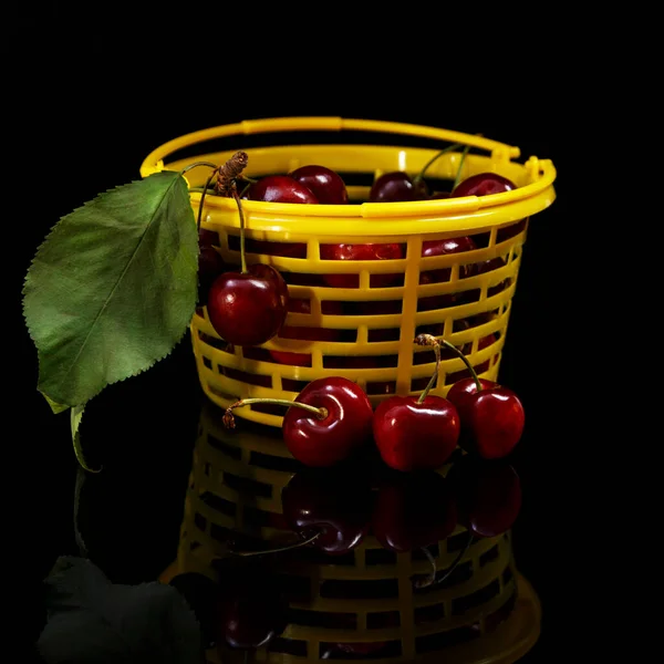 Ripe Tasty Cherries Yellow Basket Black Background — Stok fotoğraf