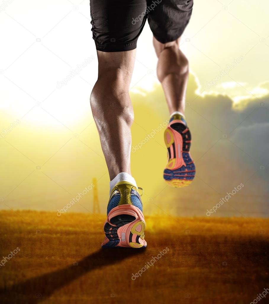 Close up feet with running shoes and strong athletic legs of sport man