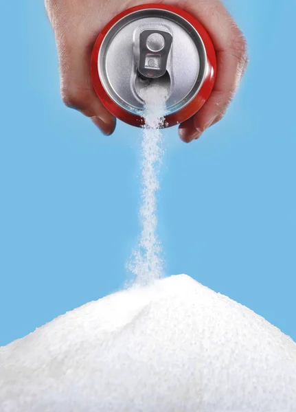 Hand holding soda can pouring a crazy amount of sugar in metaphor of sugar content — Stock Photo, Image