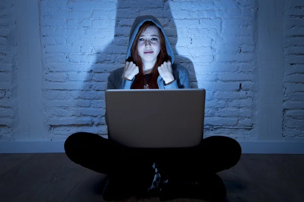 Scared female teenager with computer laptop suffering cyberbullying and harassment being online abused — Stock Photo, Image