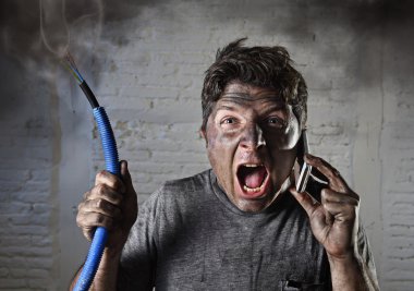 young man calling for help after accident with dirty burnt face in funny sad expression