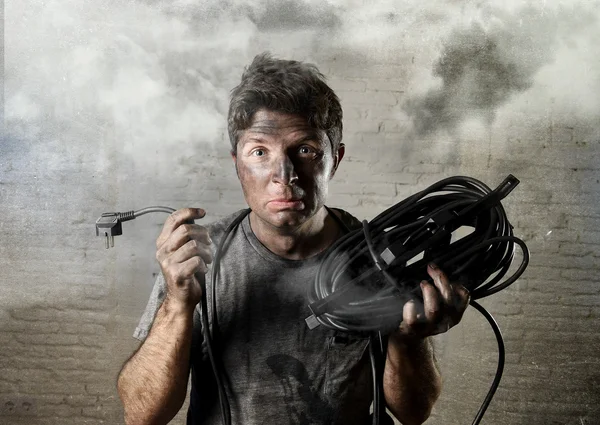 Untrained man cable suffering electrical accident with dirty burnt face in funny shock expression — Stok fotoğraf