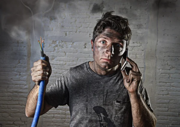 young man calling for help after accident with dirty burnt face in funny sad expression