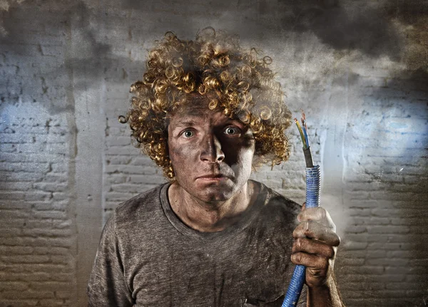 Man with cable smoking after domestic accident with dirty burnt face shock electrocuted expression — Stock Photo, Image