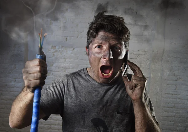 Young man calling for help after accident with dirty burnt face in funny sad expression — Stok fotoğraf