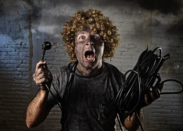 Man with cable smoking after domestic accident with dirty burnt face shock electrocuted expression — Stockfoto