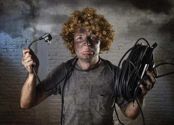 Man with cable smoking after domestic accident with dirty burnt face shock electrocuted expression — Zdjęcie stockowe