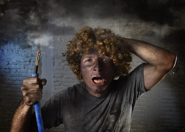 Man with cable smoking after domestic accident with dirty burnt face shock electrocuted expression — Stok fotoğraf