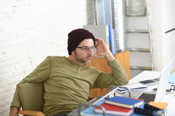 Young attractive hipster businessman working from his home office as freelancer self employed business model — Zdjęcie stockowe