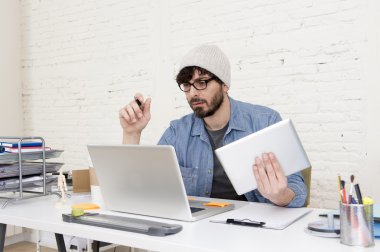 young hispanic attractive hipster businessman working at modern home office