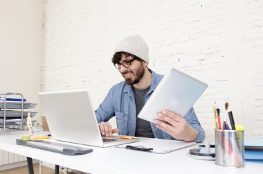 young hispanic attractive hipster businessman working at modern home office