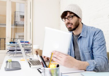 young hispanic attractive hipster businessman working at modern home office