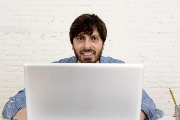 Corporate portrait of young hispanic hipster businessman working at computer home office — Stock Photo, Image