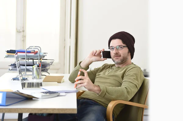 Young attractive hipster businessman working from home office with mobile phone — Stock Photo, Image