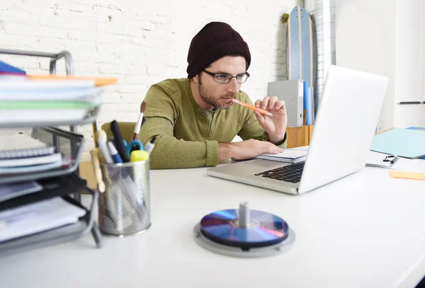 Young hipster businessman working with computer in home office as creative freelancer — Stock Fotó