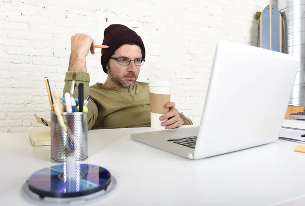 Young attractive hipster businessman working from his home office as freelancer self employed business model — Stockfoto