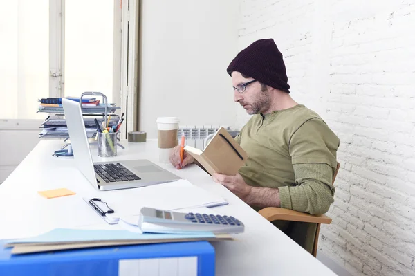 Young attractive hipster businessman working from his home office as freelancer self employed business model — Stockfoto