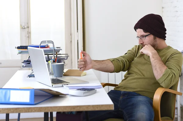 Happy attractive hipster businessman working with computer laptop at home office — Stock Photo, Image