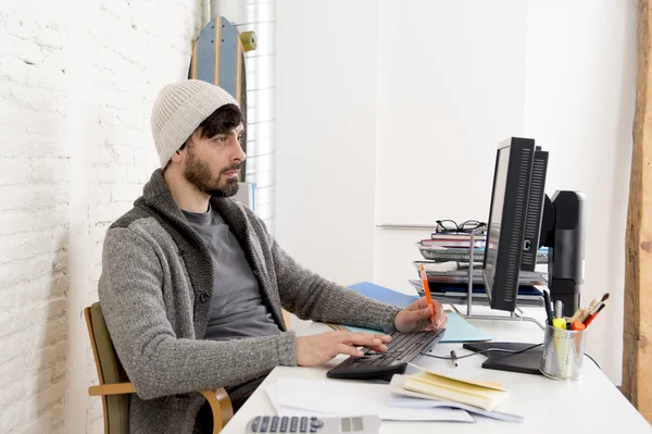 Young worried businessman in cool hipster beanie look looking desperate having problem working in stress — Stockfoto