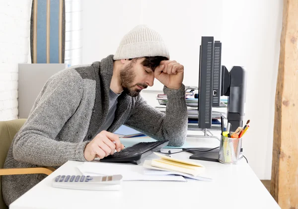 Young worried businessman in cool hipster beanie look looking desperate having problem working in stress — Stock Photo, Image