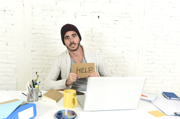 Worried businessman in cool hipster beanie look holding help sign working in stress at home office — Zdjęcie stockowe