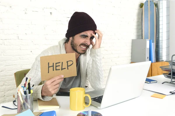 Worried businessman in cool hipster beanie look holding help sign working in stress at home office — Zdjęcie stockowe