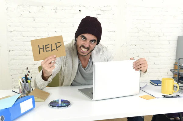 Worried businessman in cool hipster beanie look holding help sign working in stress at home office — Stok fotoğraf