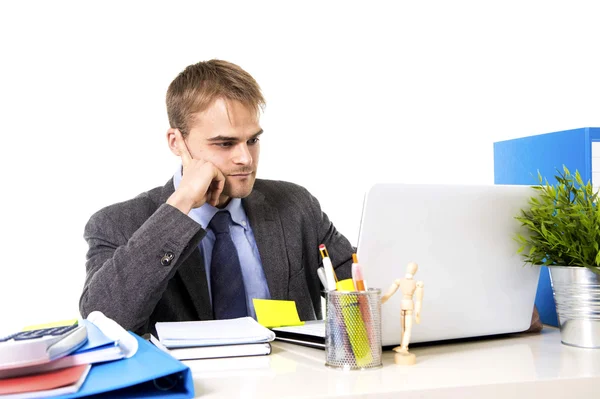 Jonge aantrekkelijke zakenman werken bezig met laptopcomputer holding pen doordachte glimlachen — Stockfoto