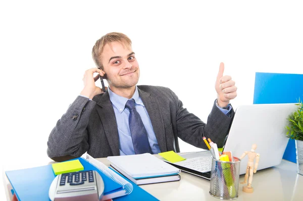 Junger glücklicher Geschäftsmann lächelt selbstbewusst und telefoniert am Schreibtisch im Büro — Stockfoto