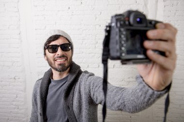selfie çekim video fotoğraf makinesi ve fotoğraf tutan genç blogger adam hippi tarzı