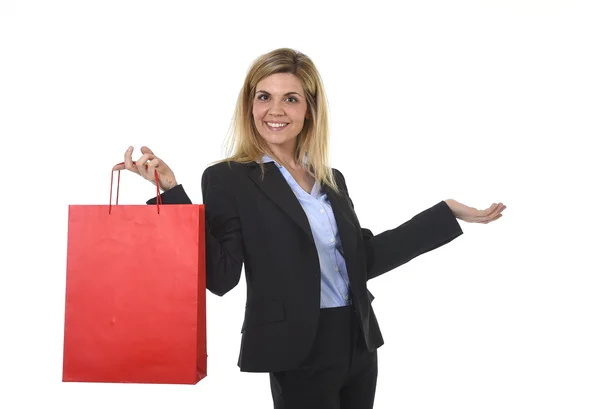 Young happy beautiful woman in business suit in excited face expression holding red shopping bag — Stock Photo, Image