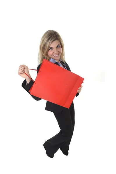 Jovem mulher bonita feliz em terno de negócios na expressão rosto animado segurando saco de compras vermelho — Fotografia de Stock