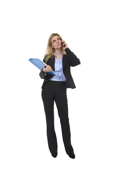 Businesswoman talking on mobile phone holding office folder and pen looking busy and worried — Stock Photo, Image