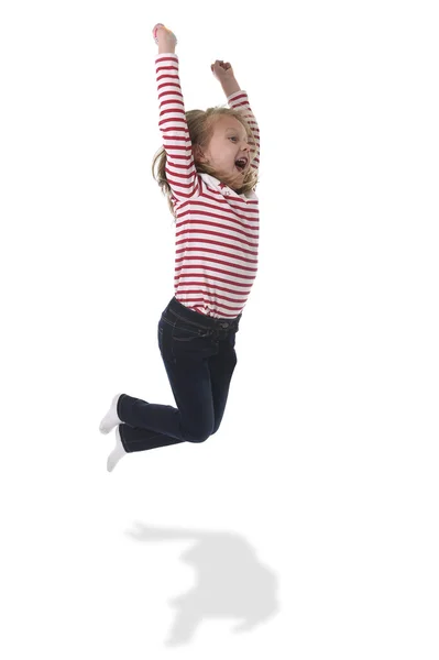 Female child with blond hair jumping happy and crazy rising arms in body language education concept — Stock Photo, Image