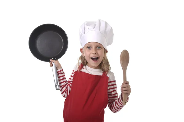 6 or 7 years old little girl in cooking hat and red apron playin — Stock Photo, Image