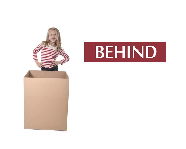 Cute and sweet blond hair child standing behind cardboard box learning English card set — Stock Photo, Image